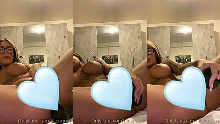 Alex Mucci playing with a black dildo