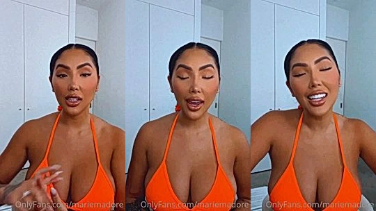 Marie Madore shaking her big tits in her orange bikini