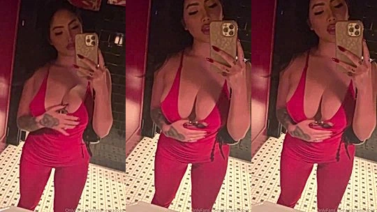 Marie Madore showing off her sexy red bodysuit in the mirror