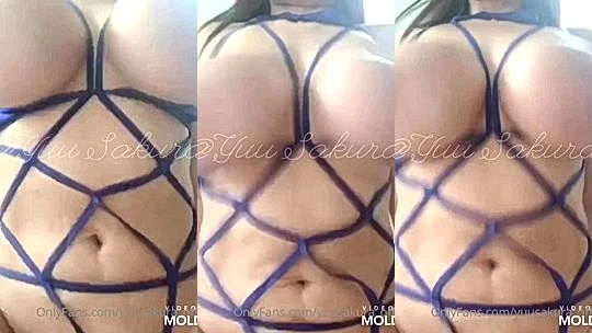 Yuu Sakura teasing her big tits in her blue string lingerie