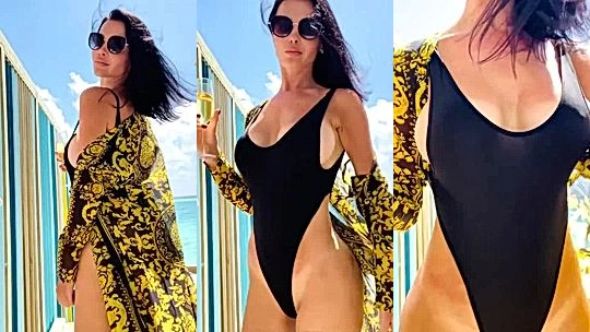 Emma Glover showing off her hot body in her black swimsuit