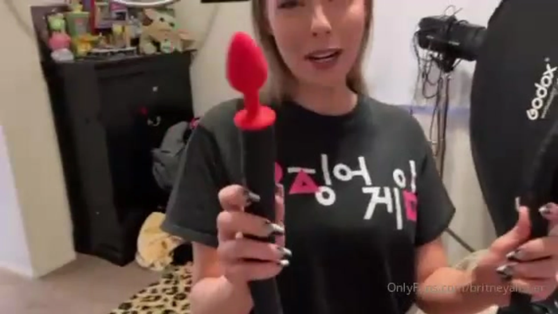Britney Amber teasing her sexy red vibrator sex toy