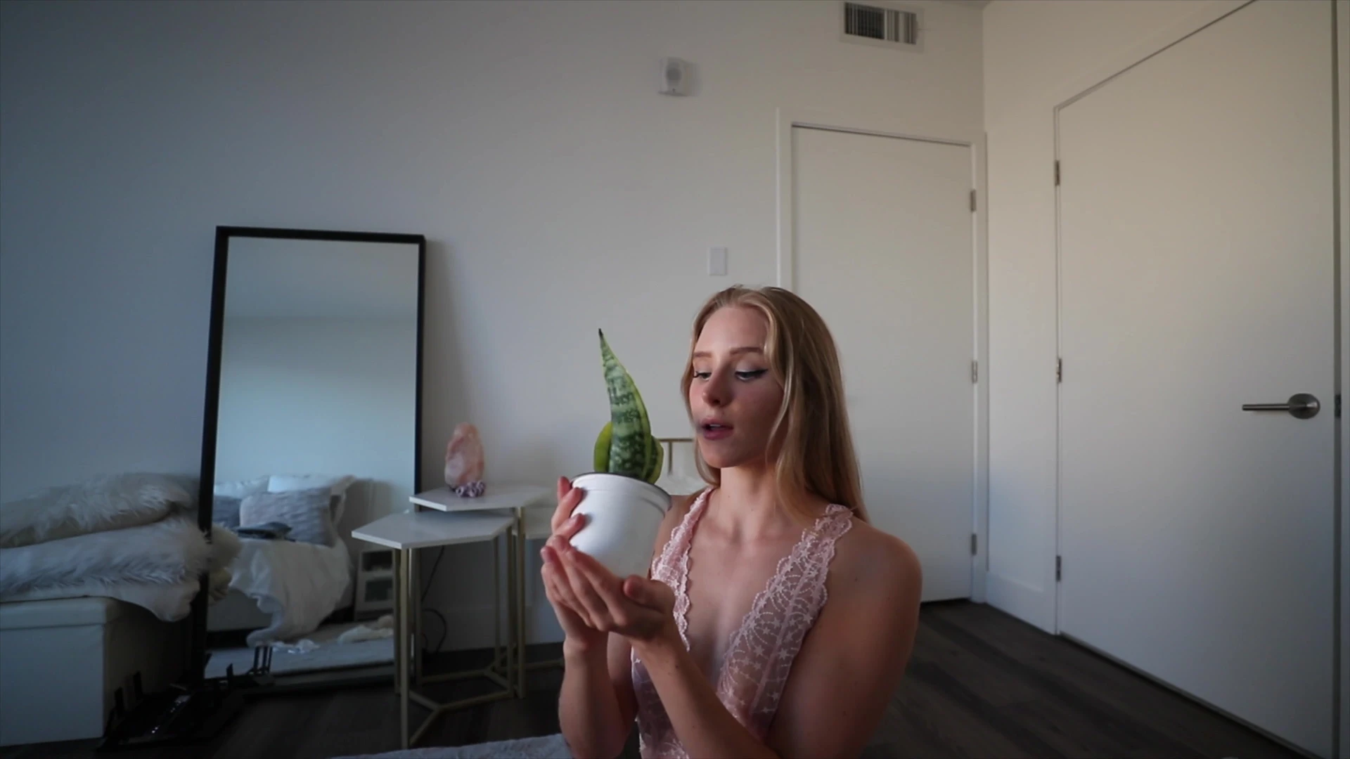 Caroline Zalog teasing her sexy see-through bodysuit with a plant