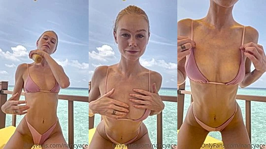 Nancy Ace showing off her sexy bikini body by the beach