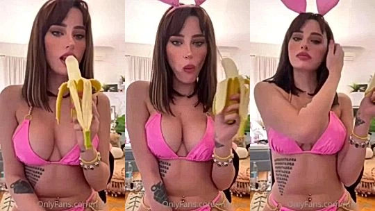 Merisiel Irum eating a banana wearing pink lingerie