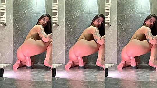 Sonya Jess riding a big white wall dildo on the ground