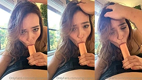 OMGCosplay sucking on a big white dildo