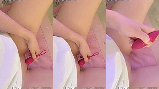 Milkimind playing with a red vibrator