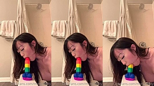 Mvngokitty sucking on a rainbow dildo
