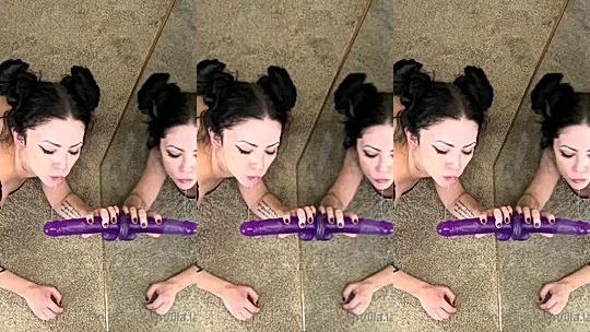 Lila Layne sucking a purple wall dildo on a mirror