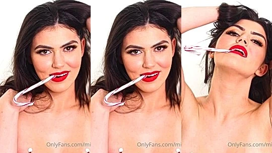 Mikaela Pascal teasing her sexy naked tits with a candy cane
