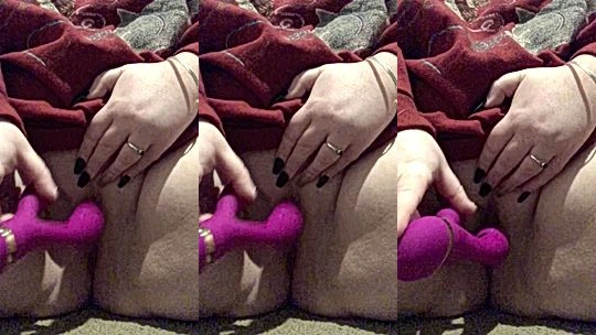 Lara Rose playing with a pink dildo in bed