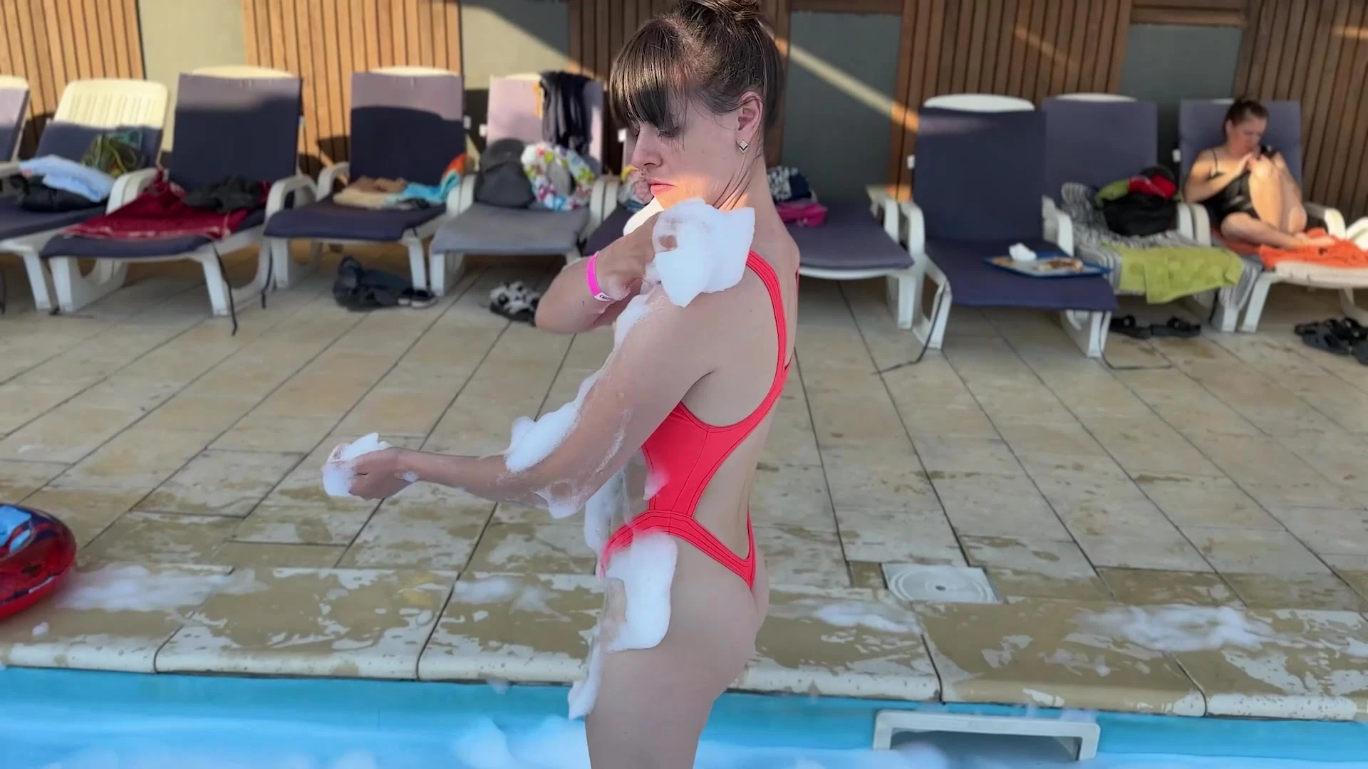 Natalie Flowers teasing her soapy swimsuit in the pool